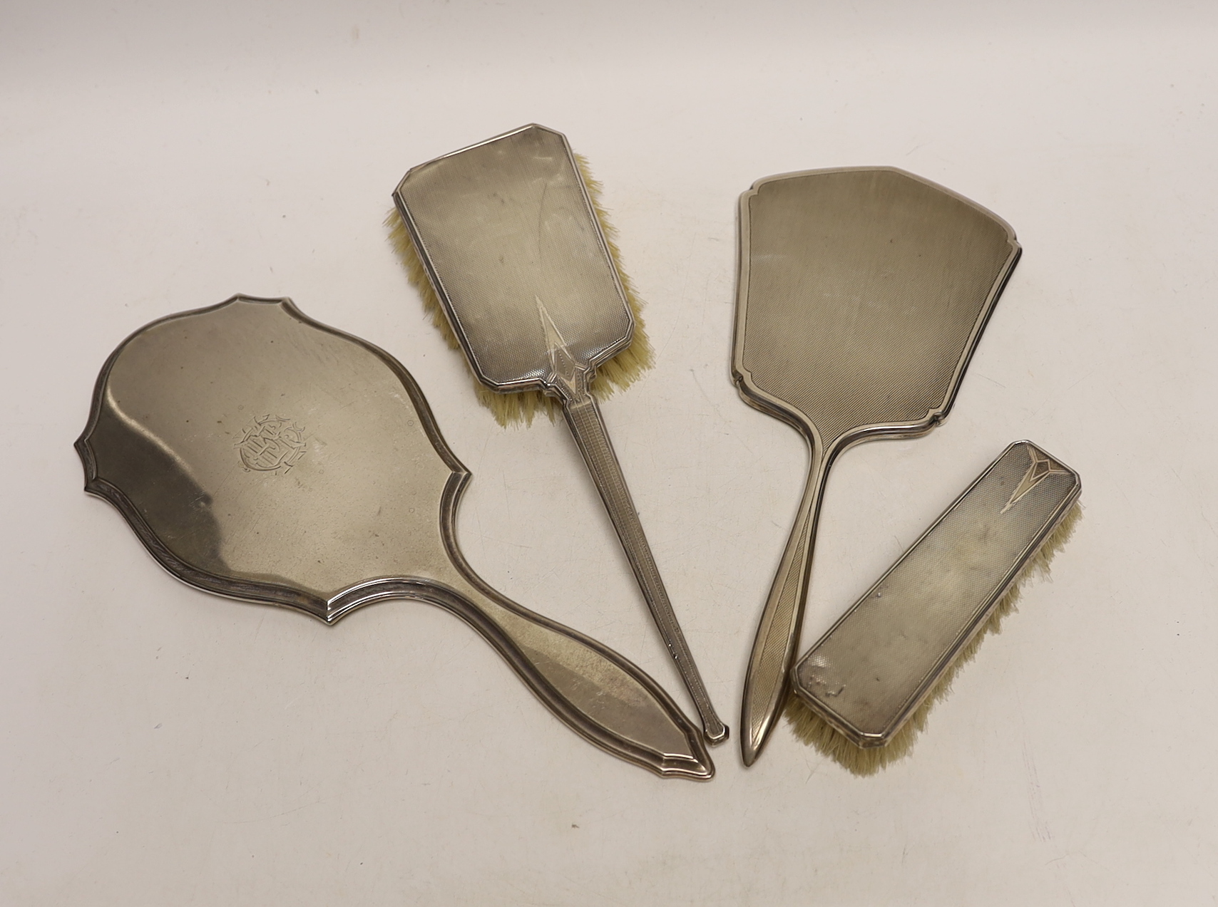 Two silver mounted hair/clothes brushes and two silver mounted hand mirrors, including Edwardian.